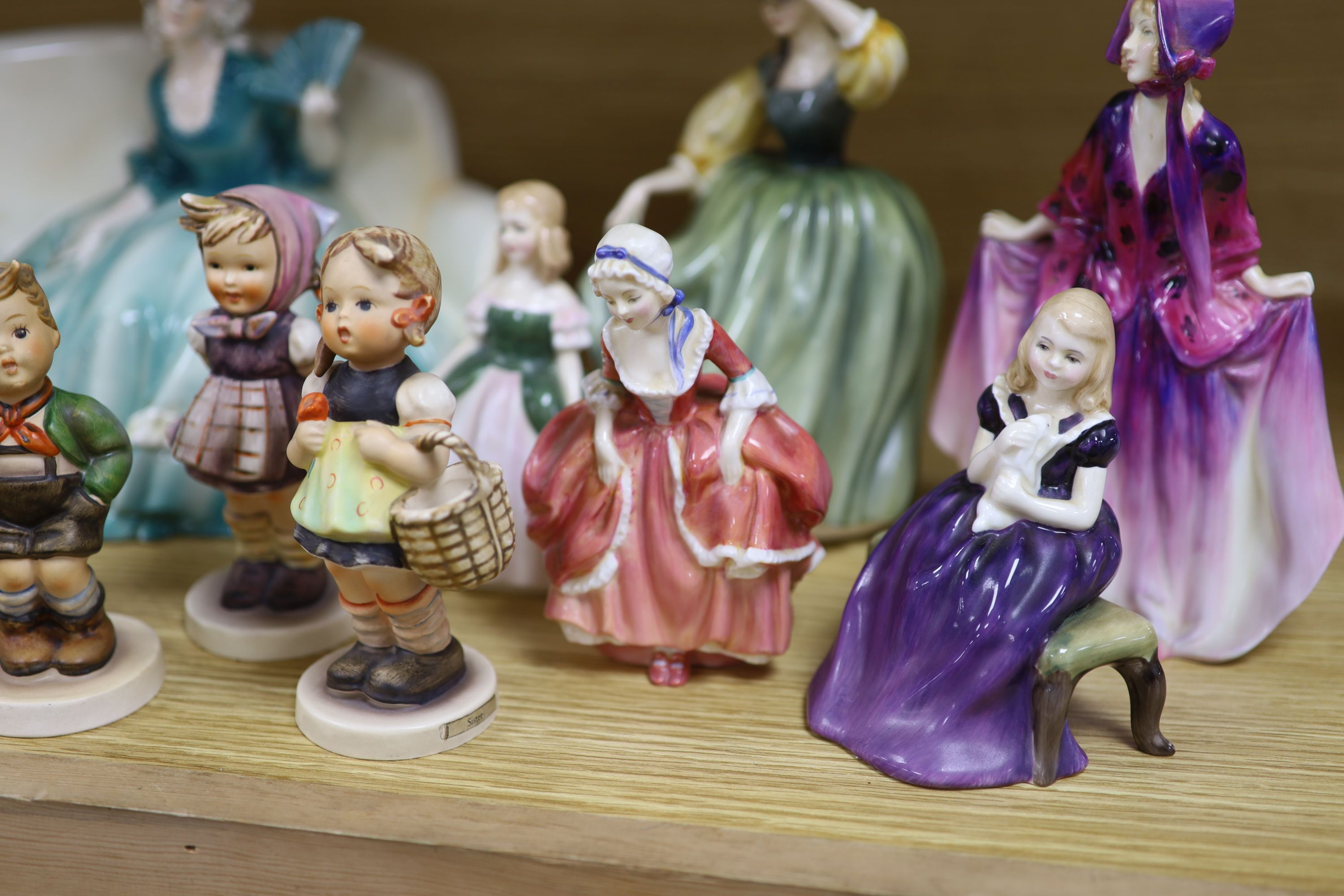 A collection of Hummel figures and Doulton ladies and a Katzhutte figure on a settee